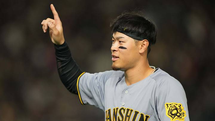 Mar 15, 2025; Bunkyo, Tokyo, Japan; Hanshin Tigers right fielder Teruaki Sato (8) gestures during the fifth inning against the Chicago Cubs at Tokyo Dome. Mandatory Credit: Darren Yamashita-Imagn Images