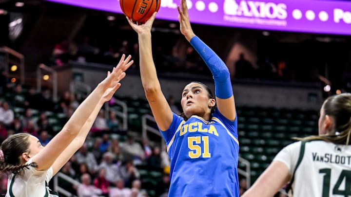 UCLA's Lauren Betts, center, shoots between Michigan State's Ines Sotelo, left, and Grace VanSlooten during the first quarter on Wednesday, Feb. 11, 2026, at the Breslin Center in East Lansing.