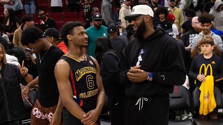 Mar 28, 2023; Houston, TX, USA; West guard Bronny James (6) with father LeBron James following the McDonald's All American Boy's high school basketball game at Toyota Center. Mandatory Credit: Mark J. Rebilas-USA TODAY Sports