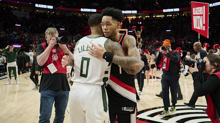 Jan 31, 2024; Portland, Oregon, USA; Portland Trail Blazers guard Anfernee Simons (1) embraces Milwaukee Bucks guard Damian Lillard (0) after a game at Moda Center. Mandatory Credit: Troy Wayrynen-Imagn Images