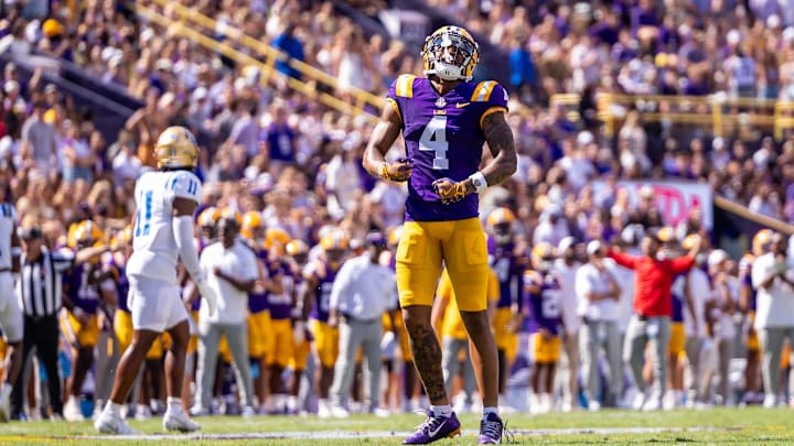 Sep 21, 2024; Baton Rouge, Louisiana, USA;  LSU Tigers wide receiver CJ Daniels (4) reacts after missing a pass against UCLA Bruins defensive back Ramon Henderson (11) during the first half at Tiger Stadium. Mandatory Credit: Stephen Lew-Imagn Images