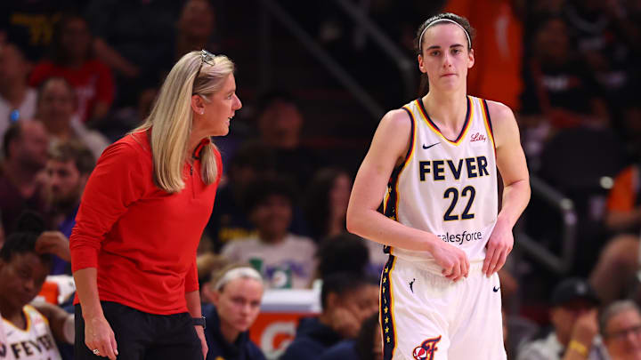 Jun 30, 2024; Phoenix, Arizona, USA; Indiana Fever head coach Christie Sides with guard Caitlin Clark (22) against the Phoenix Mercury during a WNBA game at Footprint Center. Mandatory Credit: Mark J. Rebilas-Imagn Images