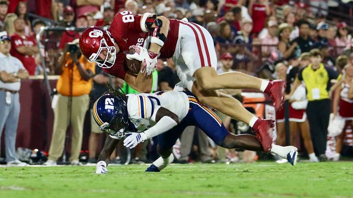 Oklahoma tight end Hayden Hansen dives forward after making a catch against UTEP. Oklahoma tight end Hayden Hansen dives forward after making a catch against UTEP.