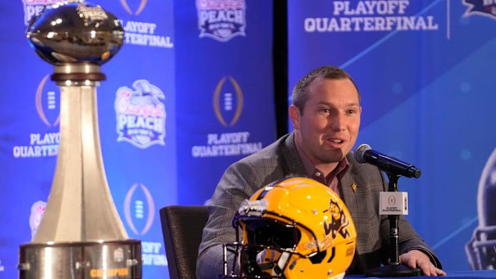 Arizona State head coach Kenny Dillingham responds to a question during a joint news conference with Texas head coach Steve Sarkisian before facing off in the Chick-fil-A Peach Bowl.