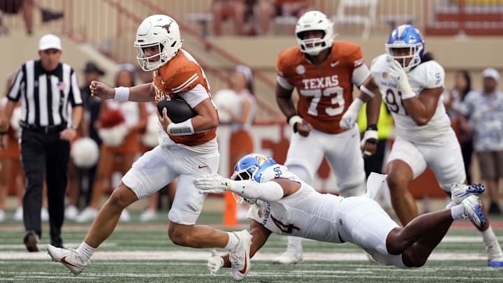 Sep 6, 2025; Austin, Texas, USA; Texas Longhorns quarterback Arch Manning (16) is tackled by San Jose State Spartans after keeping the ball for yardage during the first half at Darrell K Royal-Texas Memorial Stadium. Mandatory Credit: Scott Wachter-Imagn Images
