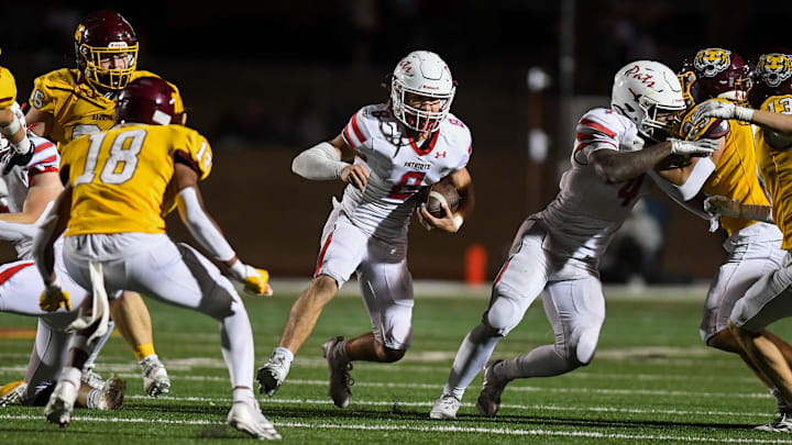 Lincoln quarterback Brody Schafer (8) runs with the ball on Thursday, Oct. 24, 2024, at Harrisburg High School in Harrisburg, South Dakota.