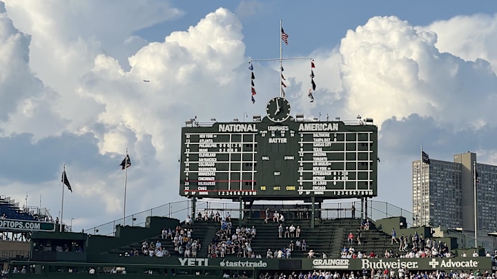 Jun 17, 2025; Chicago, Illinois, USA; Clouds surround the scoreboard before a game between the Chicago Cubs and the Milwaukee Brewers at Wrigley Field. Mandatory Credit: David Banks-Imagn Images
