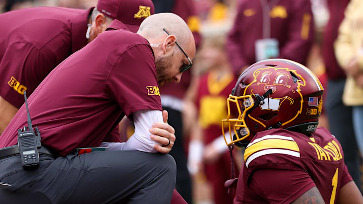Sep 6, 2025; Minneapolis, Minnesota, USA; Minnesota Golden Gophers running back Darius Taylor (1) is looked at by training staff during the first quarter against the Northwestern State Demons at Huntington Bank Stadium. Mandatory Credit: Matt Krohn-Imagn Images