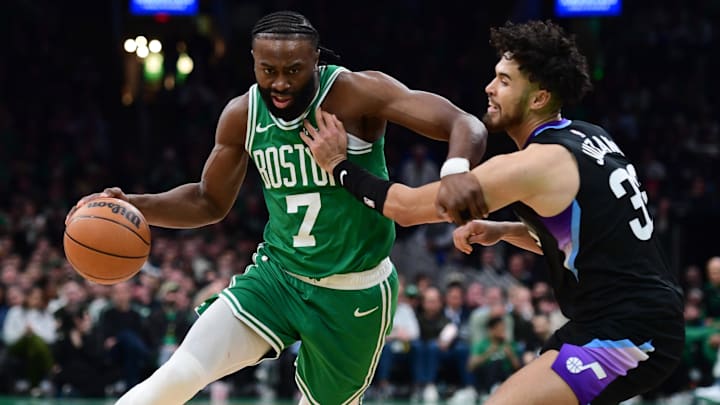 Mar 10, 2025; Boston, Massachusetts, USA; Boston Celtics guard Jaylen Brown (7) controls the ball while Utah Jazz guard Johnny Juzang (33) defends during the first half at TD Garden. Mandatory Credit: Bob DeChiara-Imagn Images