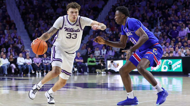 Feb 8, 2025; Manhattan, Kansas, USA; Kansas State Wildcats forward Coleman Hawkins (33) drives to the basket against Kansas Jayhawks forward Flory Bidunga (40) during the first half at Bramlage Coliseum. Mandatory Credit: Scott Sewell-Imagn Images