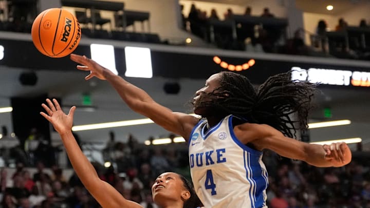 Mar 28, 2025; Birmingham, AL, USA; Duke Blue Devils forward Jadyn Donovan (4) blocks a shot by North Carolina Tar Heels guard Indya Nivar (24) at Legacy Arena in the Sweet 16. Duke advanced to the Elite 8 with a 47-38 victory. Mandatory Credit: Gary Cosby Jr.-Tuscaloosa News Mar 28, 2025; Birmingham, AL, USA; Duke Blue Devils forward Jadyn Donovan (4) blocks a shot by North Carolina Tar Heels guard Indya Nivar (24) at Legacy Arena in the Sweet 16. Duke advanced to the Elite 8 with a 47-38 victory. Mandatory Credit: Gary Cosby Jr.-Tuscaloosa News