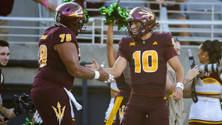 Oct 5, 2024; Tempe, Arizona, USA; Arizona State Sun Devils quarterback Sam Leavitt (10) celebrates a touchdown with offensive lineman Leif Fautanu (79) against the Kansas Jayhawks in the first half at Mountain America Stadium.