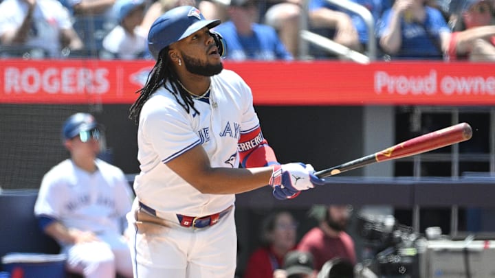 Jun 6, 2024; Toronto, Ontario, CAN;  Toronto Blue Jays first baseman Vladimir Guerrero Jr. (27) hits a three run home run against the Baltimore Orioles in the third inning at Rogers Centre.