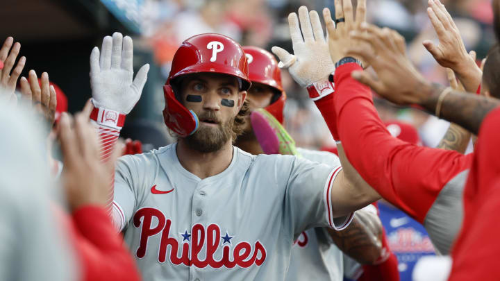 Jun 24, 2024; Detroit, Michigan, USA;  Philadelphia Phillies first baseman Bryce Harper receives congratulations from teammates.