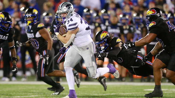 Kansas State junior tight end Ben Sinnott (34) drives through Kansas defenders during the first