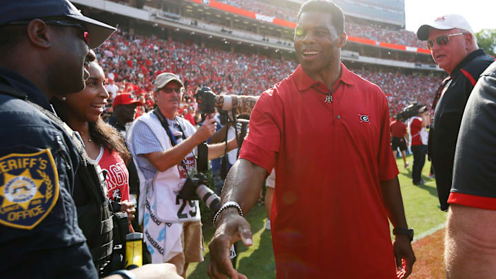 Heisman Trophy winner and U.S. Senate candidate Herschel Walker shakes hands with fan during the first half of an NCAA college football game between UAB and Georgia in Athens, Ga., on Sept 11, 2021. Georgia won 56-7.
News Joshua L Jones Heisman Trophy winner and U.S. Senate candidate Herschel Walker shakes hands with fan during the first half of an NCAA college football game between UAB and Georgia in Athens, Ga., on Sept 11, 2021. Georgia won 56-7.
News Joshua L Jones