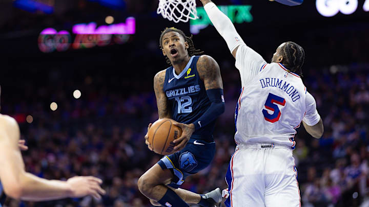 Nov 2, 2024; Philadelphia, Pennsylvania, USA; Memphis Grizzlies guard Ja Morant (12) drives for a score past Philadelphia 76ers center Andre Drummond (5) during the third quarter at Wells Fargo Center. Mandatory Credit: Bill Streicher-Imagn Images Nov 2, 2024; Philadelphia, Pennsylvania, USA; Memphis Grizzlies guard Ja Morant (12) drives for a score past Philadelphia 76ers center Andre Drummond (5) during the third quarter at Wells Fargo Center. Mandatory Credit: Bill Streicher-Imagn Images