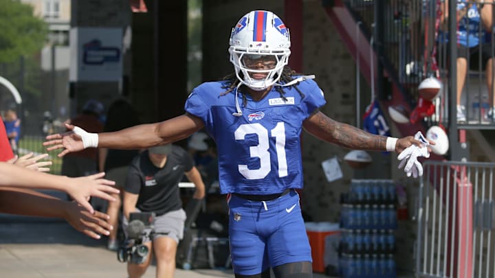 Bills rookie defensive back Maxwell Hairston high-fives fans as he runs onto the field during day five of Buffalo Bills training camp.