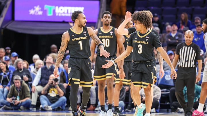 Dec 17, 2025; Memphis, Tennessee, USA; Vanderbilt Commodores guards Frankie Collins (1) and Tyler Tanner (3) high five during the second half against the Memphis Tigers at FedExForum. Mandatory Credit: Wesley Hale-Imagn Images