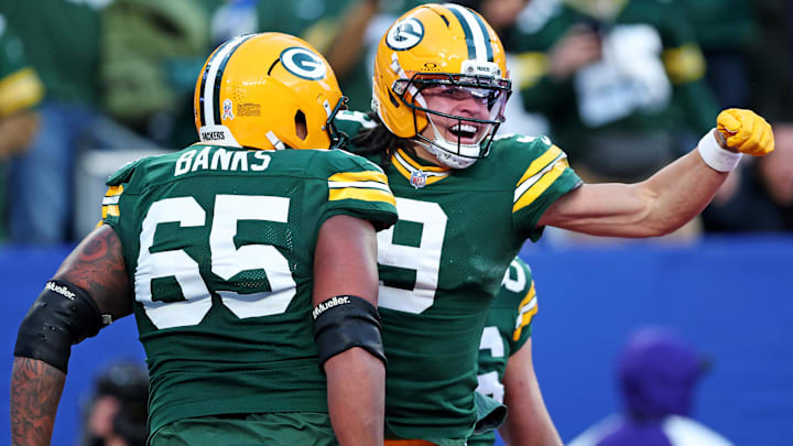 Nov 16, 2025; East Rutherford, New Jersey, USA; Green Bay Packers wide receiver Christian Watson (9) celebrates with guard Aaron Banks (65) after scoring a touchdown during the fourth quarter against the New York Giants at MetLife Stadium.