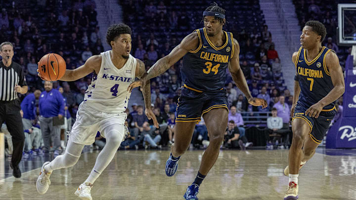 Kansas State PJ Haggerty (4) drives on Cal's Lee Dort (34) and Dai Dai Ames (7) 