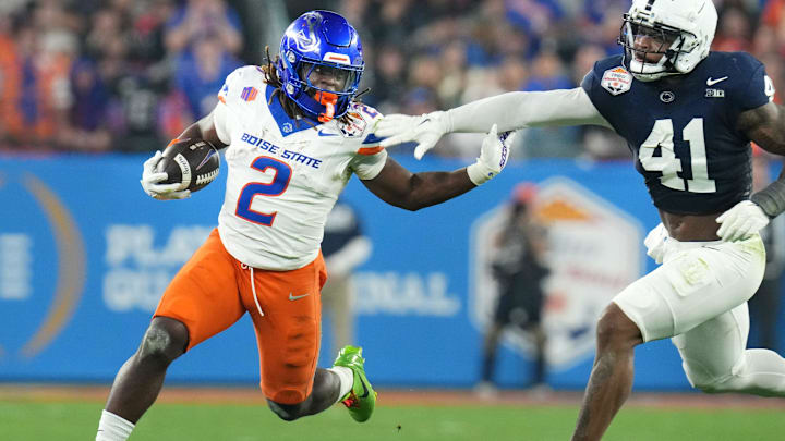 Boise State Broncos running back Ashton Jeanty (2) runs past Penn State Nittany Lions linebacker Kobe King (41) during their Vrbo Fiesta Bowl matchup at State Farm Stadium on Dec. 31, 2024. Boise State Broncos running back Ashton Jeanty (2) runs past Penn State Nittany Lions linebacker Kobe King (41) during their Vrbo Fiesta Bowl matchup at State Farm Stadium on Dec. 31, 2024.