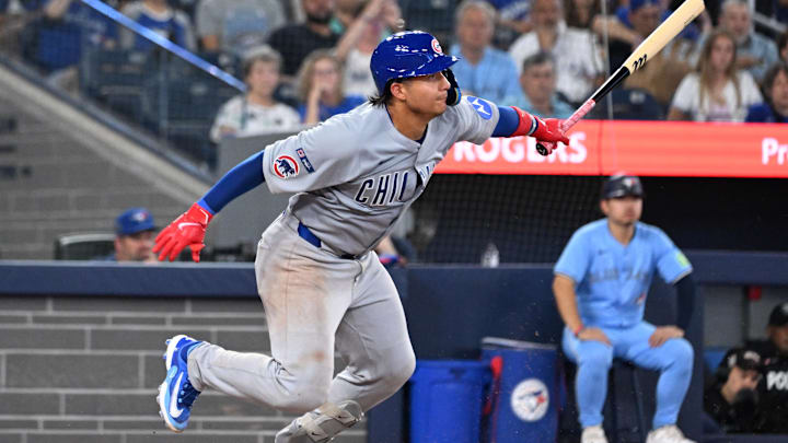 Aug 13, 2025; Toronto, Ontario, CAN;  Chicago Cubs catcher Miguel Amaya (9) hits an infield single against the Toronto Blue Jays in the eighth inning at Rogers Centre. Mandatory Credit: Dan Hamilton-Imagn Images