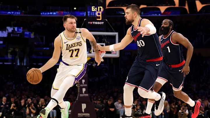 Mar 2, 2025; Los Angeles, California, USA; Los Angeles Lakers guard Luka Doncic (77) dribbles against LA Clippers center Ivica Zubac (40) and guard James Harden (1) during the second quarter at Crypto.com Arena. Mandatory Credit: Jason Parkhurst-Imagn Images Mar 2, 2025; Los Angeles, California, USA; Los Angeles Lakers guard Luka Doncic (77) dribbles against LA Clippers center Ivica Zubac (40) and guard James Harden (1) during the second quarter at Crypto.com Arena. Mandatory Credit: Jason Parkhurst-Imagn Images