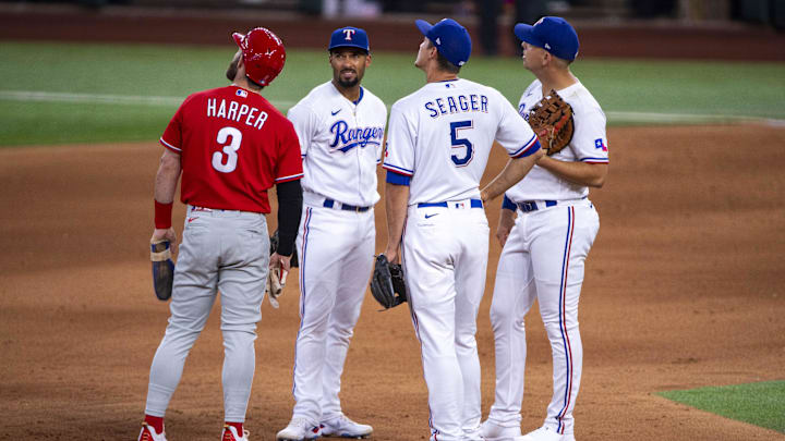 Jun 22, 2022; Arlington, Texas, USA; Philadelphia Phillies designated hitter Bryce Harper (3) and Texas Rangers second baseman Marcus Semien (2) and shortstop Corey Seager (5) and first baseman Nathaniel Lowe (30) watch the replay screen during the sixth inning at Globe Life Field. Mandatory Credit: Jerome Miron-Imagn Images Jun 22, 2022; Arlington, Texas, USA; Philadelphia Phillies designated hitter Bryce Harper (3) and Texas Rangers second baseman Marcus Semien (2) and shortstop Corey Seager (5) and first baseman Nathaniel Lowe (30) watch the replay screen during the sixth inning at Globe Life Field. Mandatory Credit: Jerome Miron-Imagn Images