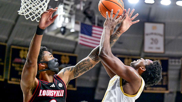 Feb 16, 2025; South Bend, Indiana, USA; Notre Dame Fighting Irish guard Brady Stevens (0) is fouled by Louisville Cardinals forward James Scott (0) in the first half at the Purcell Pavilion. Mandatory Credit: Matt Cashore-Imagn Images Feb 16, 2025; South Bend, Indiana, USA; Notre Dame Fighting Irish guard Brady Stevens (0) is fouled by Louisville Cardinals forward James Scott (0) in the first half at the Purcell Pavilion. Mandatory Credit: Matt Cashore-Imagn Images
