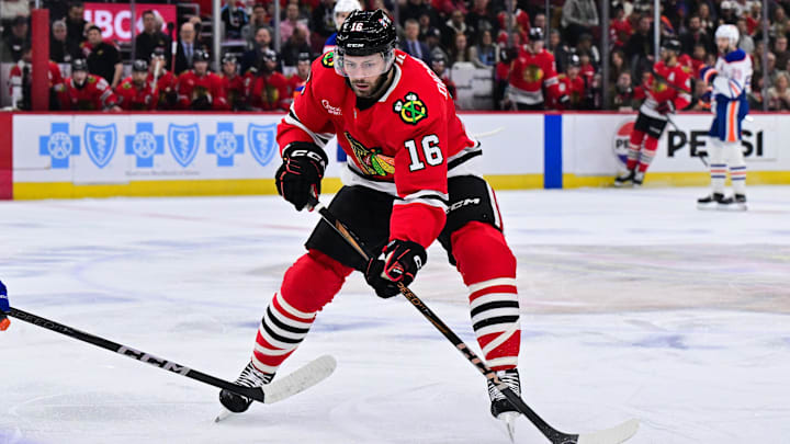 Feb 5, 2025; Chicago, Illinois, USA; Chicago Blackhawks center Jason Dickinson (16) plays the puck against the Edmonton Oilers during the first period at the United Center. Mandatory Credit: Daniel Bartel-Imagn Images