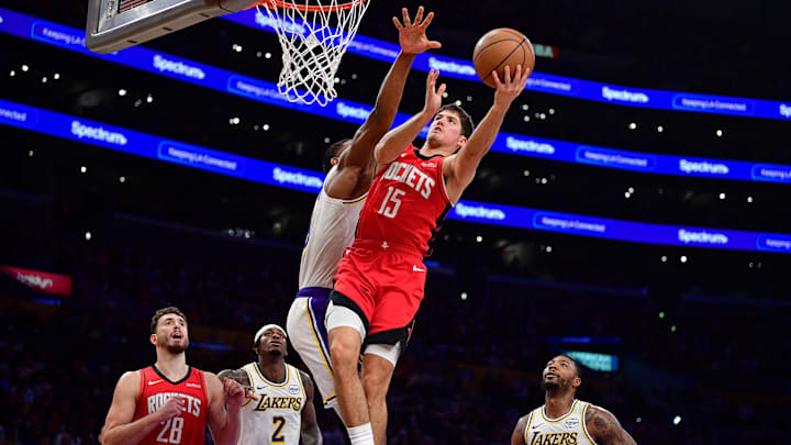 Dec 25, 2025; Los Angeles, California, USA; Houston Rockets guard Reed Sheppard (15) moves to the basket against Los Angeles Lakers forward Rui Hachimura (28) during the second half at Crypto.com Arena. Mandatory Credit: Gary A. Vasquez-Imagn Images