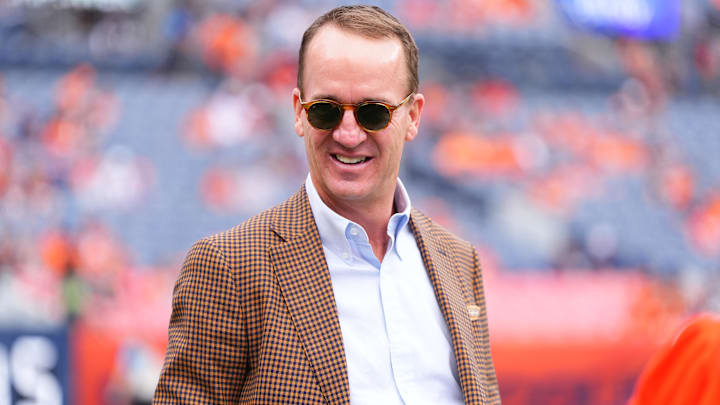 Retired NFL player Peyton Manning stands on the sidelines of Empower Field at Mile High before the game between the Carolina Panthers Denver Broncos. Retired NFL player Peyton Manning stands on the sidelines of Empower Field at Mile High before the game between the Carolina Panthers Denver Broncos.