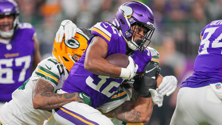 Dec 31, 2023; Minneapolis, Minnesota, USA; Minnesota Vikings running back Ty Chandler (32) runs with the ball against the Green Bay Packers in the first quarter at U.S. Bank Stadium.
