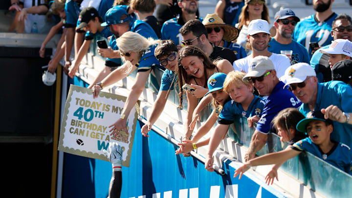Jacksonville Jaguars linebacker Devin Lloyd (0) high-fives fans after the game of an NFL football matchup at EverBank Stadium, Sunday, Sept. 21, 2025, in Jacksonville, Fla. The Jaguars defeated the Texans 17-10.