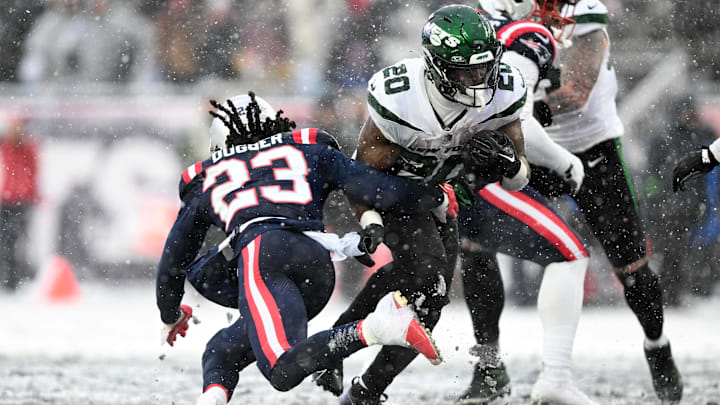 Jan 7, 2024; Foxborough, Massachusetts, USA; New York Jets running back Breece Hall (20) runs against New England Patriots safety Kyle Dugger (23) during the second half at Gillette Stadium. Mandatory Credit: Brian Fluharty-Imagn Images