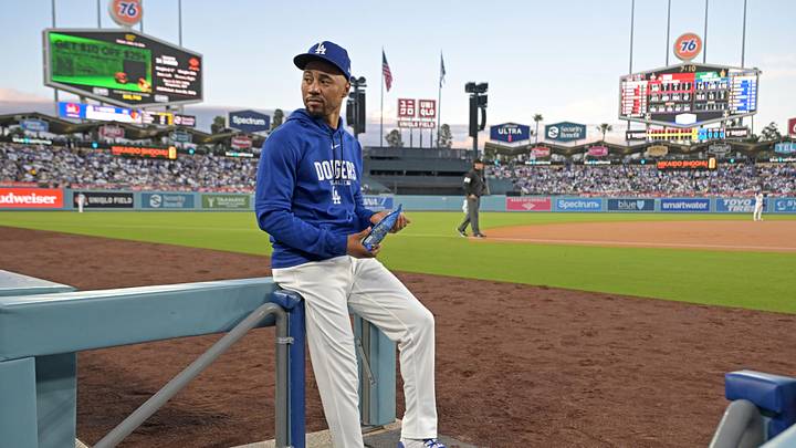 Apr 10, 2026; Los Angeles, California, USA; Los Angeles Dodgers shortstop Mookie Betts (50) looks on from the dugout steps during the game against the Texas Rangers at Dodger Stadium. Mandatory Credit: Jayne Kamin-Oncea-Imagn Images