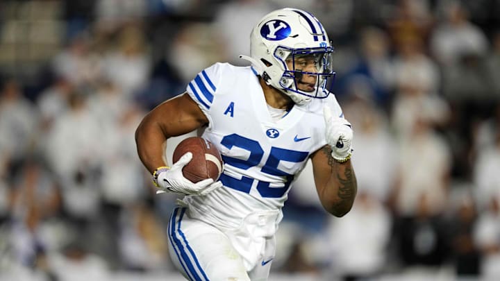 Sep 18, 2021; Provo, Utah, USA; BYU Cougars running back Tyler Allgeier (25) carries the ball in the first quarter against the Arizona State Sun Devils at LaVell Edwards Stadium. Mandatory Credit: Kirby Lee-Imagn Images