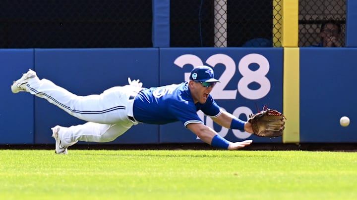 Mar 2, 2023; Dunedin, Florida, USA; Toronto Blue Jays right fielder Daulton Varsho (25) dives for a