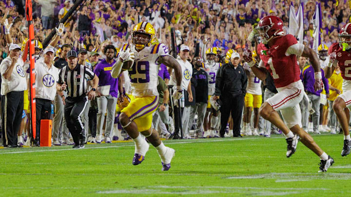 Nov 9, 2024; Baton Rouge, Louisiana, USA; Alabama Crimson Tide defensive back Domani Jackson (1) tackles LSU Tigers running back Caden Durham (29) at Tiger Stadium. Mandatory Credit: Stephen Lew-Imagn Images Nov 9, 2024; Baton Rouge, Louisiana, USA; Alabama Crimson Tide defensive back Domani Jackson (1) tackles LSU Tigers running back Caden Durham (29) at Tiger Stadium. Mandatory Credit: Stephen Lew-Imagn Images