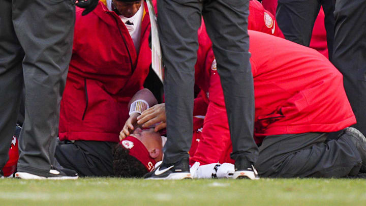 Dec 14, 2025; Kansas City, Missouri, USA; Kansas City Chiefs quarterback Patrick Mahomes (15) is attended to by team medical staff following an injury during the fourth quarter against the Los Angeles Chargers at GEHA Field at Arrowhead Stadium. Mandatory Credit: Jay Biggerstaff-Imagn Images