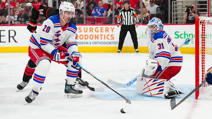 Apr 12, 2025; Raleigh, North Carolina, USA;  New York Rangers left wing Chris Kreider (20) picks up the puck in front of goaltender Igor Shesterkin (31) against the Carolina Hurricanes during the third period at Lenovo Center. Mandatory Credit: James Guillory-Imagn Images