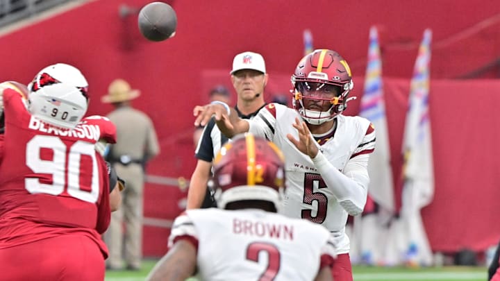 Sep 29, 2024; Glendale, Arizona, USA;  Washington Commanders quarterback Jayden Daniels (5) throws to wide receiver Dyami Brown (2) in the second half against the Arizona Cardinals at State Farm Stadium. Mandatory Credit: Matt Kartozian-Imagn Images