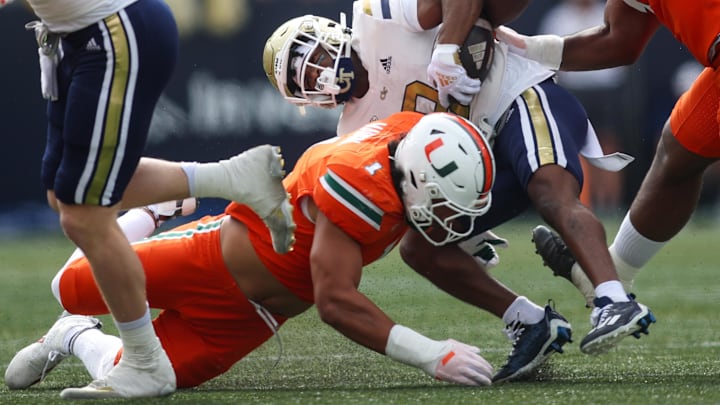 Nov 9, 2024; Atlanta, Georgia, USA; Miami Hurricanes linebacker Francisco Mauigoa (1) tackles Georgia Tech Yellow Jackets wide receiver Malik Rutherford (8) in the first quarter at Bobby Dodd Stadium at Hyundai Field. Mandatory Credit: Brett Davis-Imagn Images