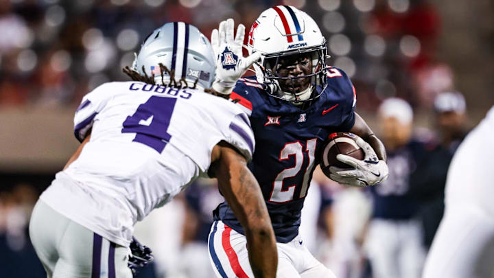 Sep 12, 2025; Tucson, Arizona, USA; Arizona Wildcats running back Ismail Mahdi (21) runs the ball while Kansas State Wildcats safety Daniel Cobbs (4) defends during the fourth quarter at Arizona Stadium. Mandatory Credit: Aryanna Frank-Imagn Images