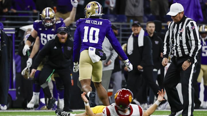 UW edge rusher Lance Holtzclaw leaves USC quarterback Miller Moss in a heap to end Saturday night's game. UW edge rusher Lance Holtzclaw leaves USC quarterback Miller Moss in a heap to end Saturday night's game.