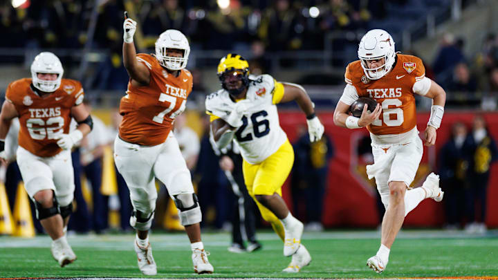 Dec 31, 2025; Orlando, FL, USA; Texas Longhorns quarterback Arch Manning (16) rushes with the ball for a touchdown against the Michigan Wolverines during the second half at Camping World Stadium. Mandatory Credit: Matt Pendleton-Imagn Images