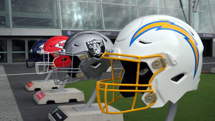 Oct 13, 2024; London, United Kingdom; Large helmets of the Los Angeles Chargers, Las Vegas Raiders, Kansas City Chiefs and Denver Broncos of the AFC West before an NFL International Series game at Tottenham Hotspur Stadium. Mandatory Credit: Kirby Lee-Imagn Images