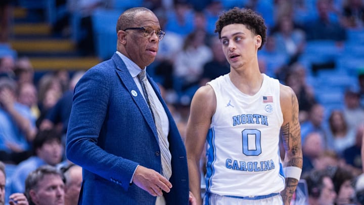 Nov 18, 2025; Chapel Hill, North Carolina, USA; North Carolina Tar Heels head coach Hubert Davis talks to guard Kyan Evans (0) during the second half against the Navy Midshipmen at Dean E. Smith Center. Mandatory Credit: Scott Kinser-Imagn Images
