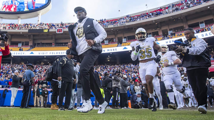 Nov 23, 2024; Kansas City, Missouri, USA; Colorado head coach Deion Sanders leads his team on to the field against the Kansas Jayhawks at GEHA Field at Arrowhead Stadium. Mandatory Credit: Nick Tre. Smith-Imagn Images Nov 23, 2024; Kansas City, Missouri, USA; Colorado head coach Deion Sanders leads his team on to the field against the Kansas Jayhawks at GEHA Field at Arrowhead Stadium. Mandatory Credit: Nick Tre. Smith-Imagn Images